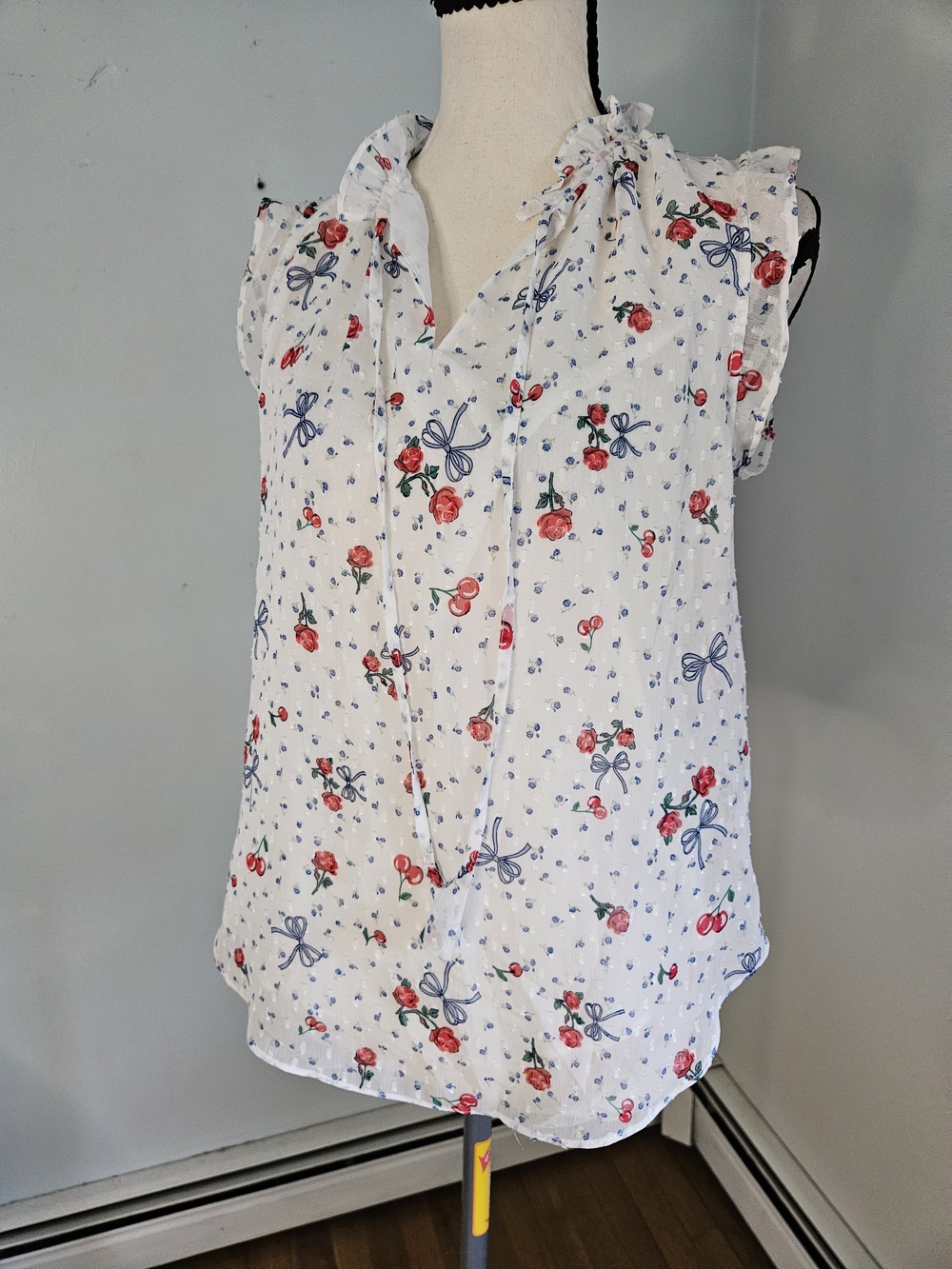Sleeveless White Floral Tie-Neck Blouse with Bow Print